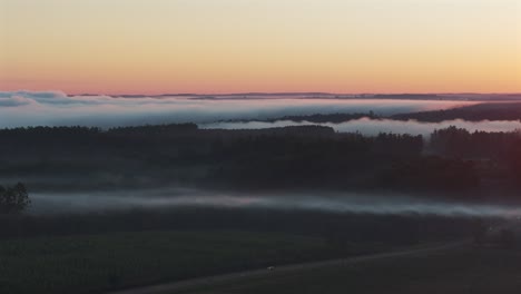 sunrise over foggy landscape