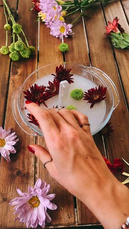 crystal healing arrangement with flowers on wooden table