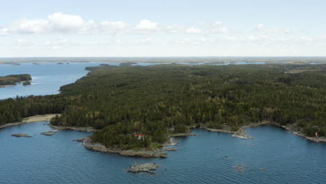 aerial, pan, drone shot of a large island at the gulf of finland, on a sunny day, in the porvoo archipelago, in uusimaa