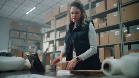 warehouse worker packing boxes