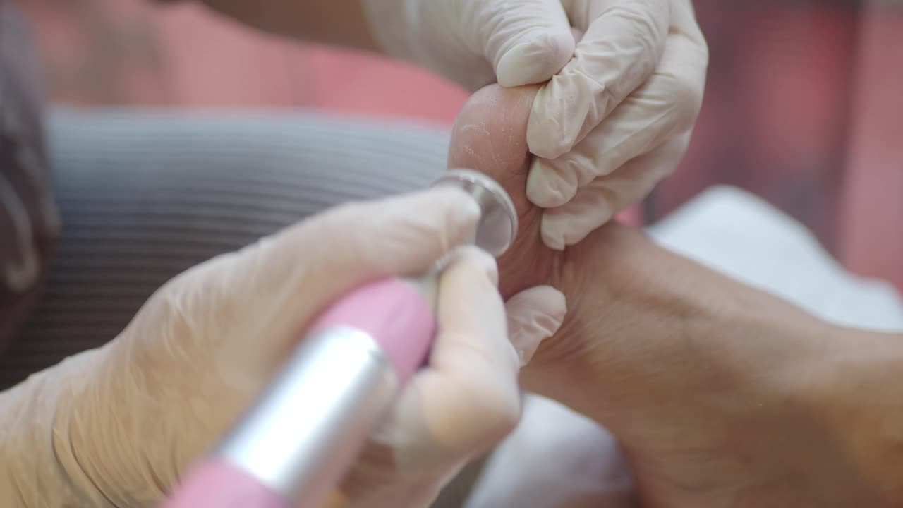 Close-up of Pedicurist Using Electric File on Client's Foot