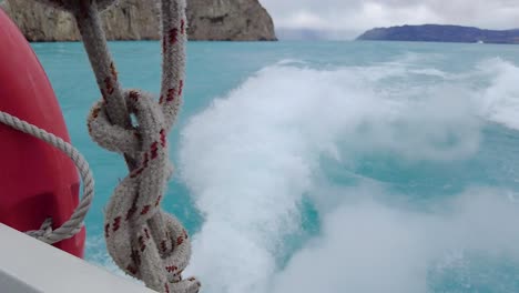 slow motion take of a propeller thrusting turquoise water with an incredible background