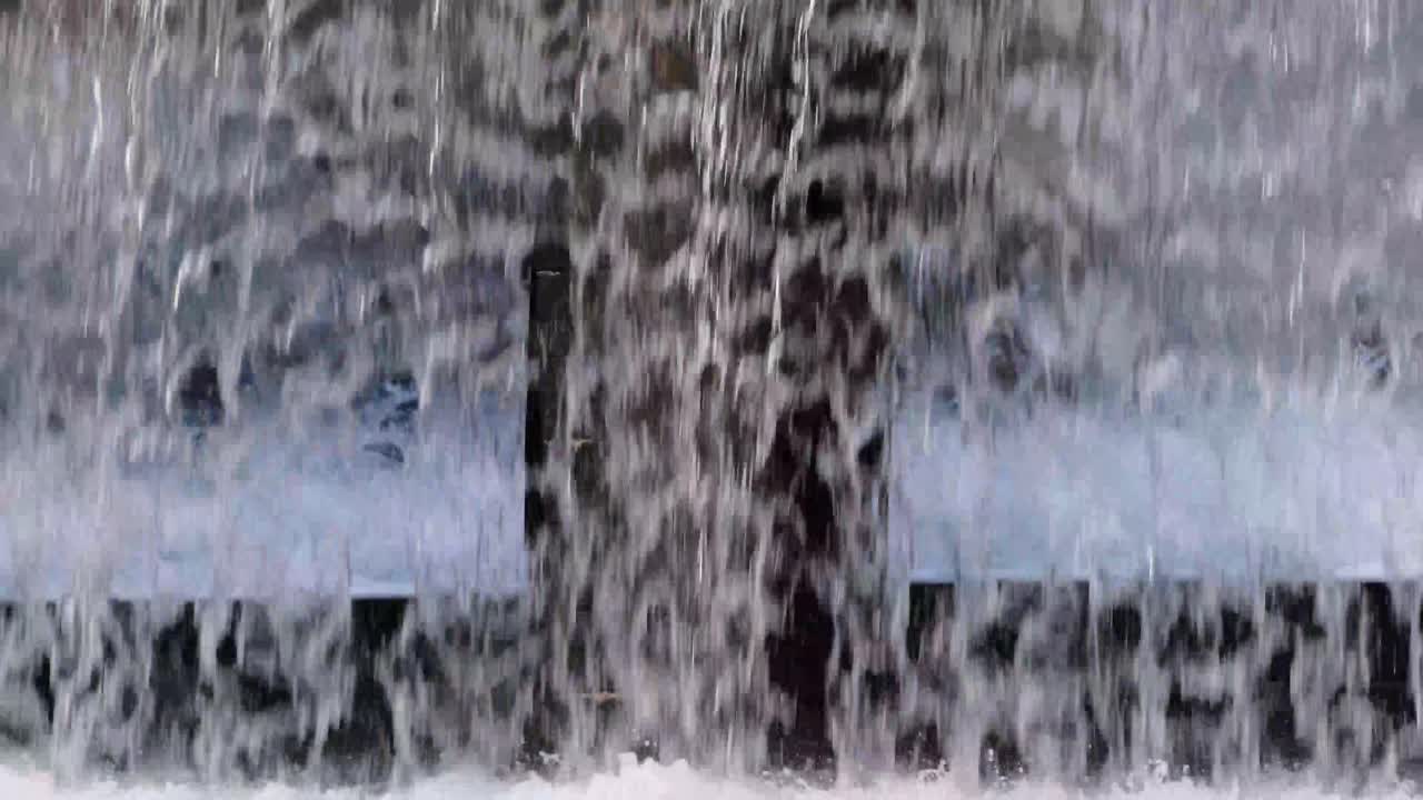 A small waterfall in the city in the evening