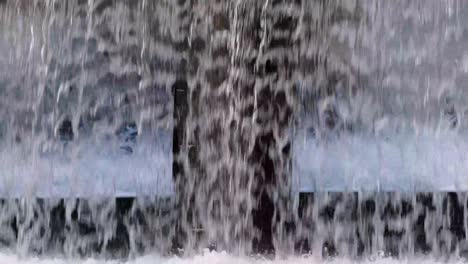 a small waterfall in the city in the evening