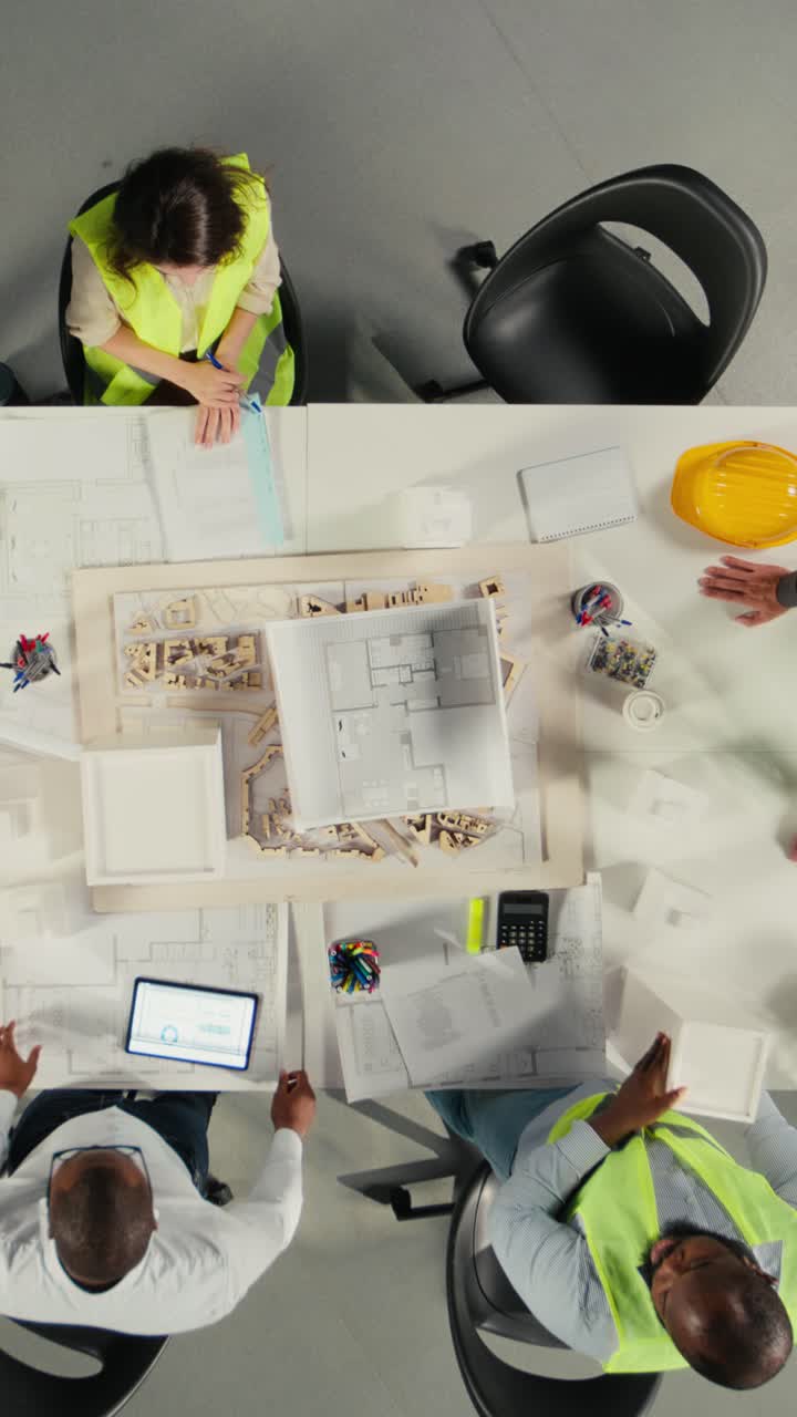 Vertical Video Top down view of architects working on real estate investment plan