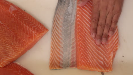 filleting delicious fresh salmon for sushi - slow motion