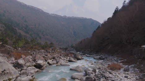dudh koshi river flows through serene himalayan terrain of nepal as trekkers ascend everest base camp, a peaceful and scenic adventure route captured by drone wilderness
