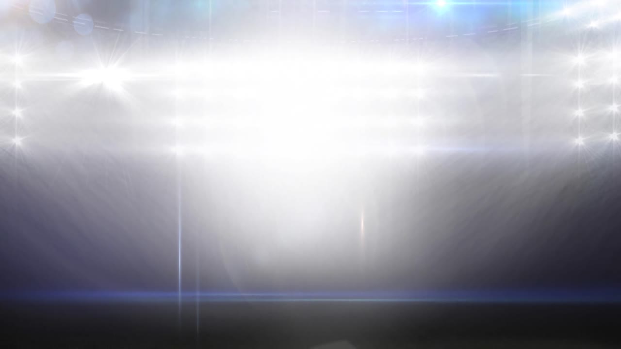 Animace rozmazaných pohyblivých světel a bokeh světelných bodů na osvětleném sportovním stadionu.