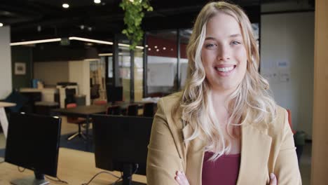 Portrait-of-happy-plus-size-caucasian-businesswoman-with-blonde-hair,-copy-space,-slow-motion