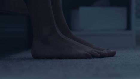 person's feet on the carpet at night