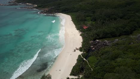 landscapes on island la dique in seychelles filmed with a drone from above showing the ocean, rocks, palm trees