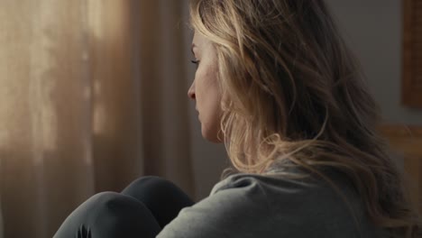 Caucasian-woman-with-mental-health-sitting-in-the-bed-and-looking-away