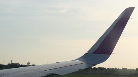 airplane wing during landing at krabi airport