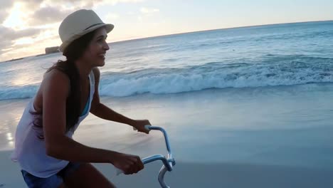 woman cycling at beach