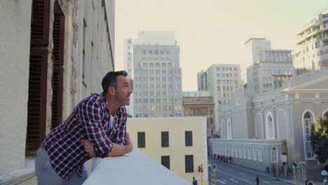 man standing in balcony at home 4k