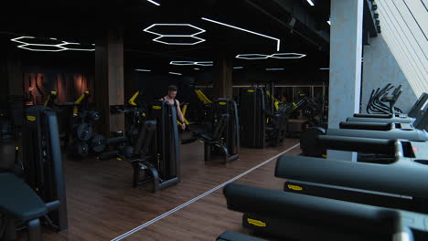 handsome man getting ready for training. man having workout on treadmill in modern gym