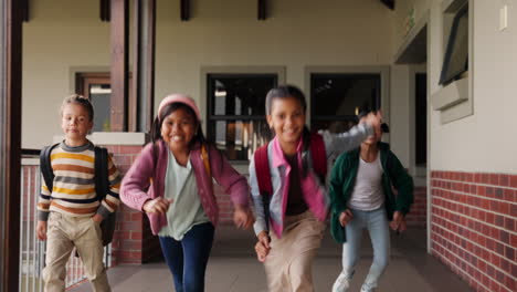 happy students running in school hallway
