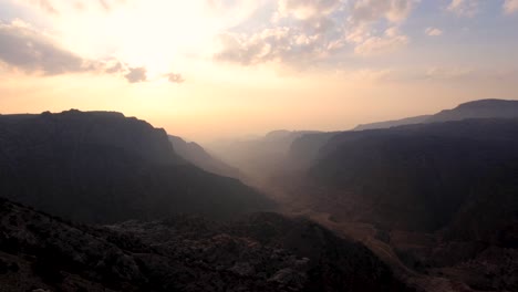 dusky sunset overlooking natural canyon valley wadi dana and dana biosphere reserve in jordan, middle east