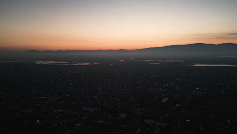 sun dipping below the horizon of the mexico city valley