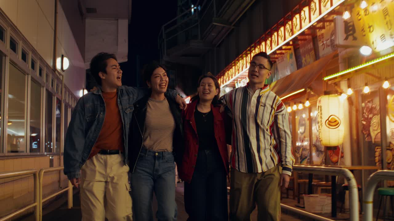 Friends enjoying a night out in a Japanese city