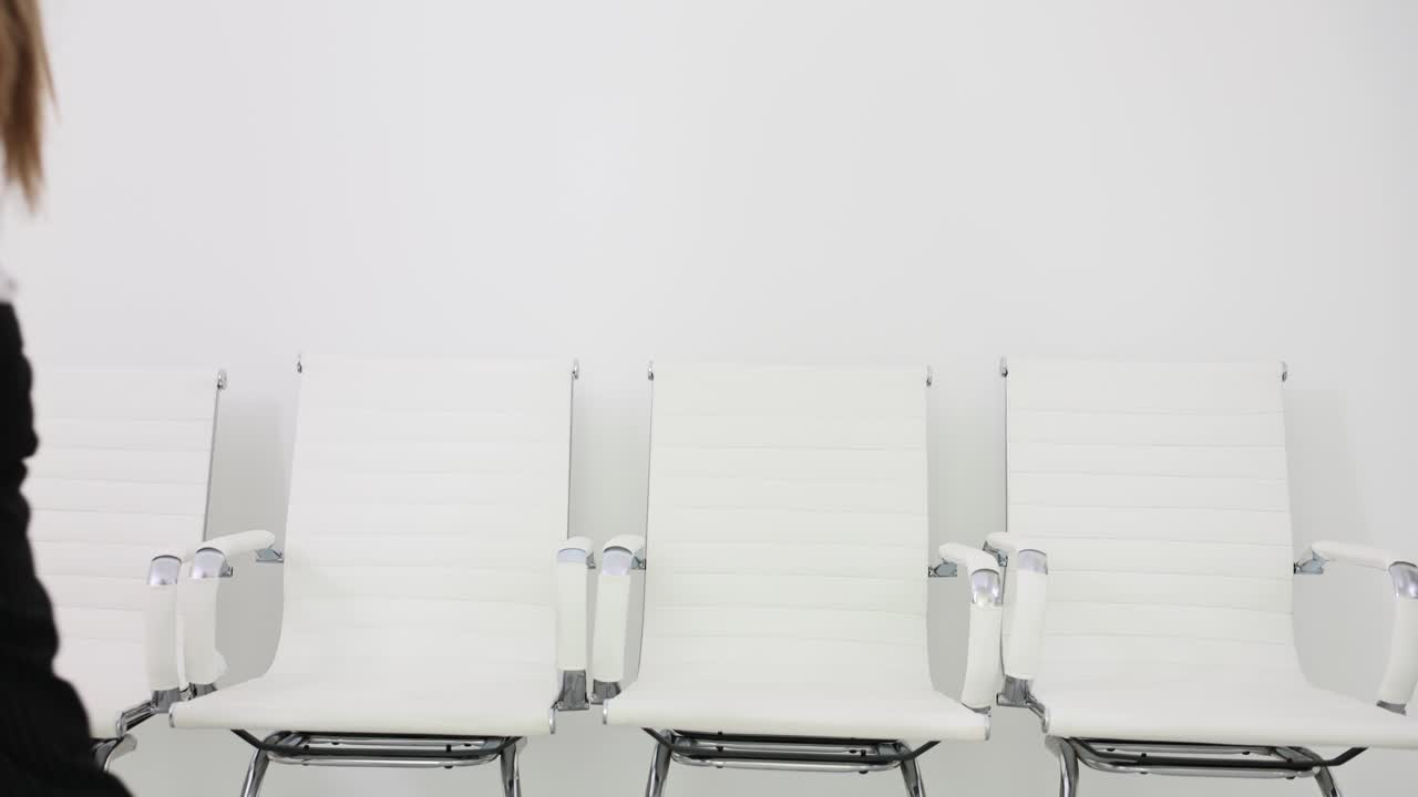 Woman in business attire in a waiting room