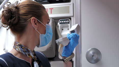 Close-Up-Stewardess-with-Mouth-Protection-Mask-Using-Public-Address