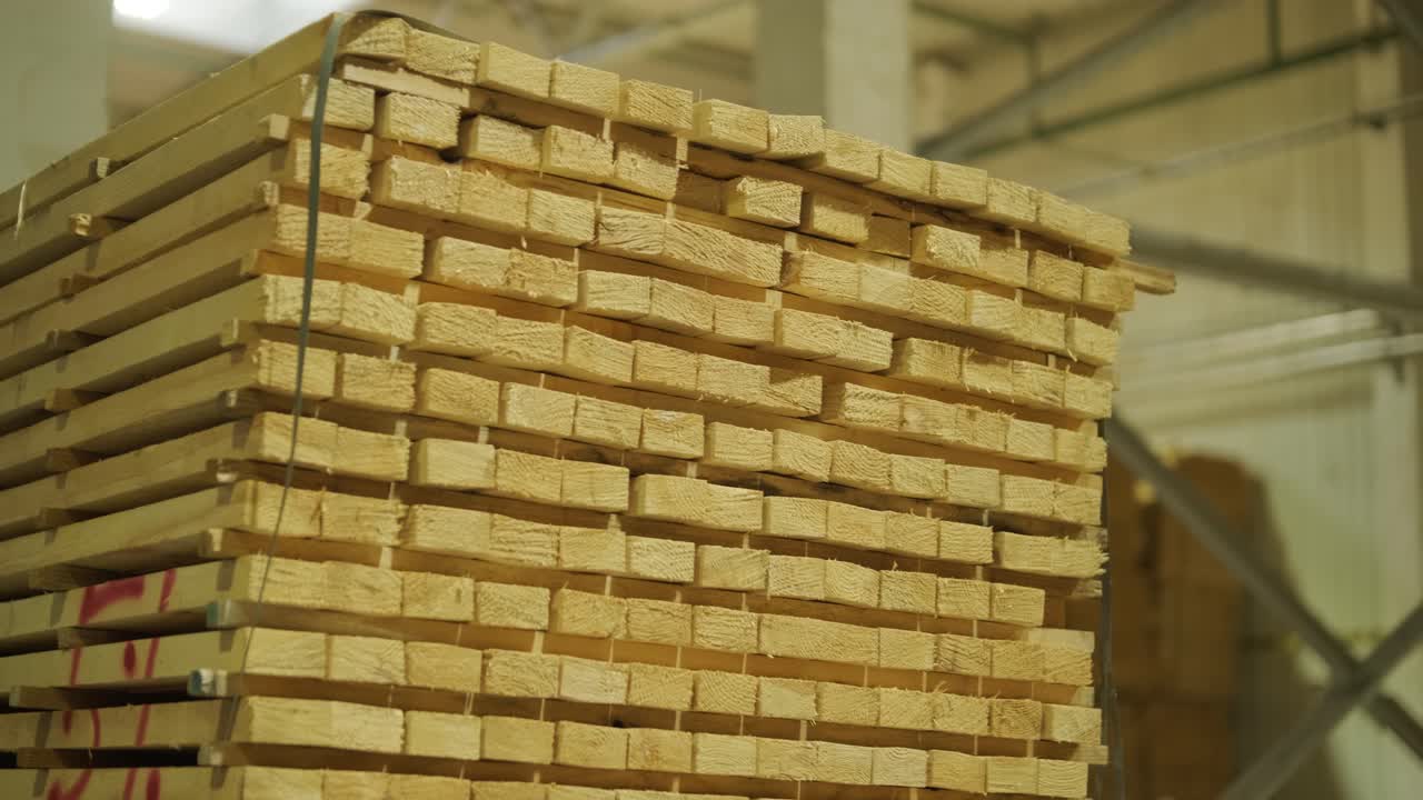 Large Stack of Wooden Planks in an Industrial Warehouse