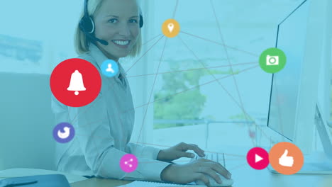 animation of network of digital icons over caucasian woman wearing phone headset smiling at office