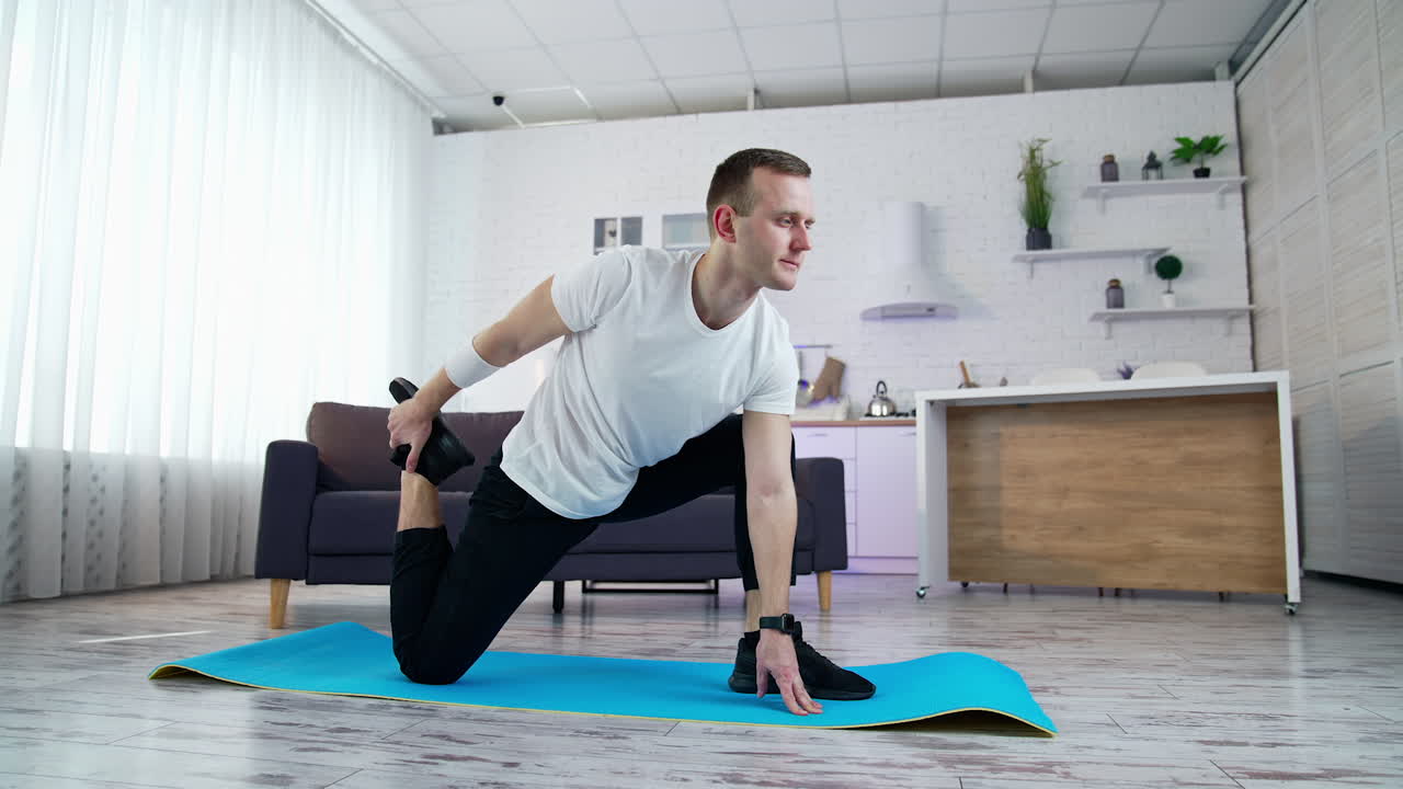 Young fit man in sportswear working out at home. Healthy lifestyle man doing yoga on quarantine.