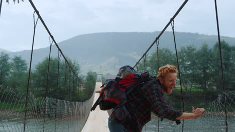 emotional tourist celebrate turn around on bridge. happy hiker jump mountains.