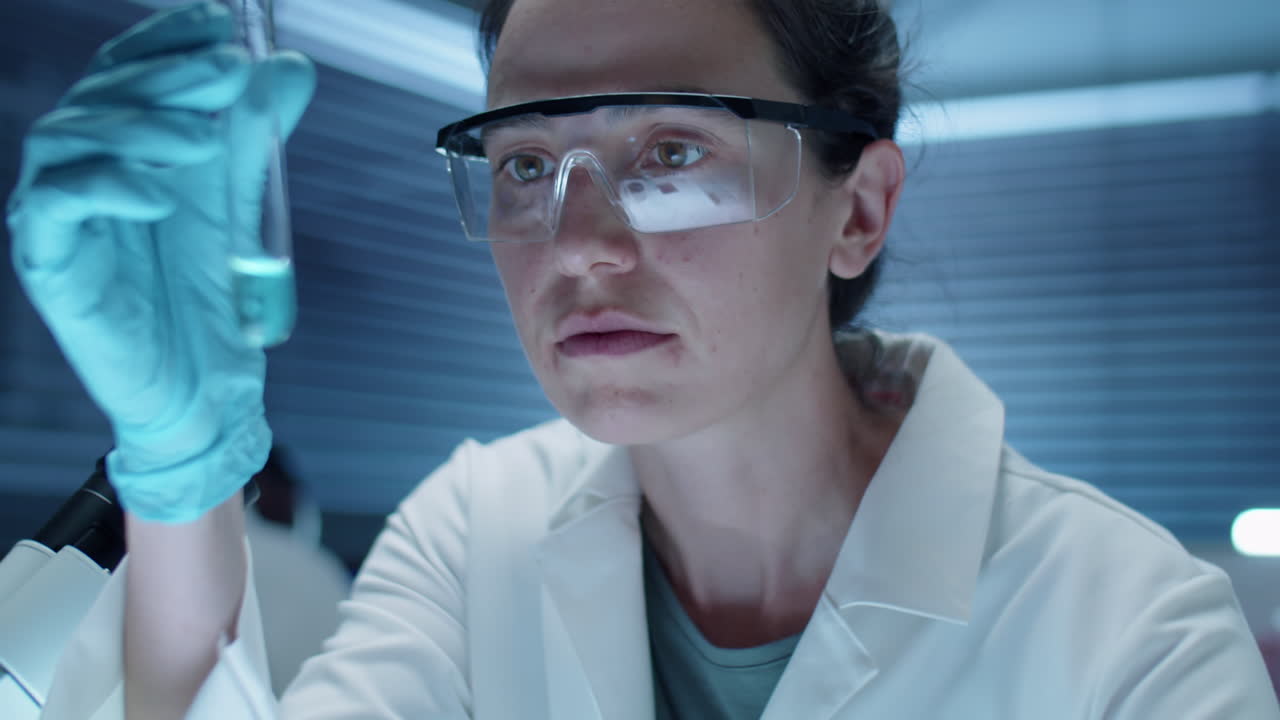 Female Chemist Examining Substance in Test Tube