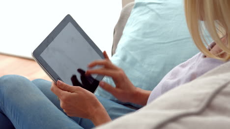 woman using tablet on couch