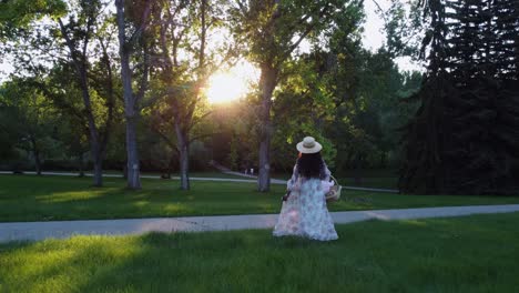 black woman with basket walking in park sun bursting followed