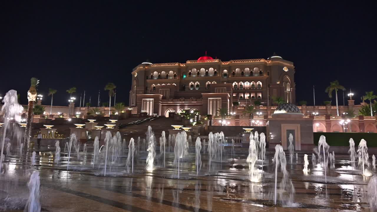 Nighttime glow of Abu Dhabi's iconic Emirates Palace Hotel in the UAE