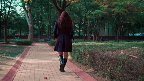 female caucasian white woman model is walking outside on the street park