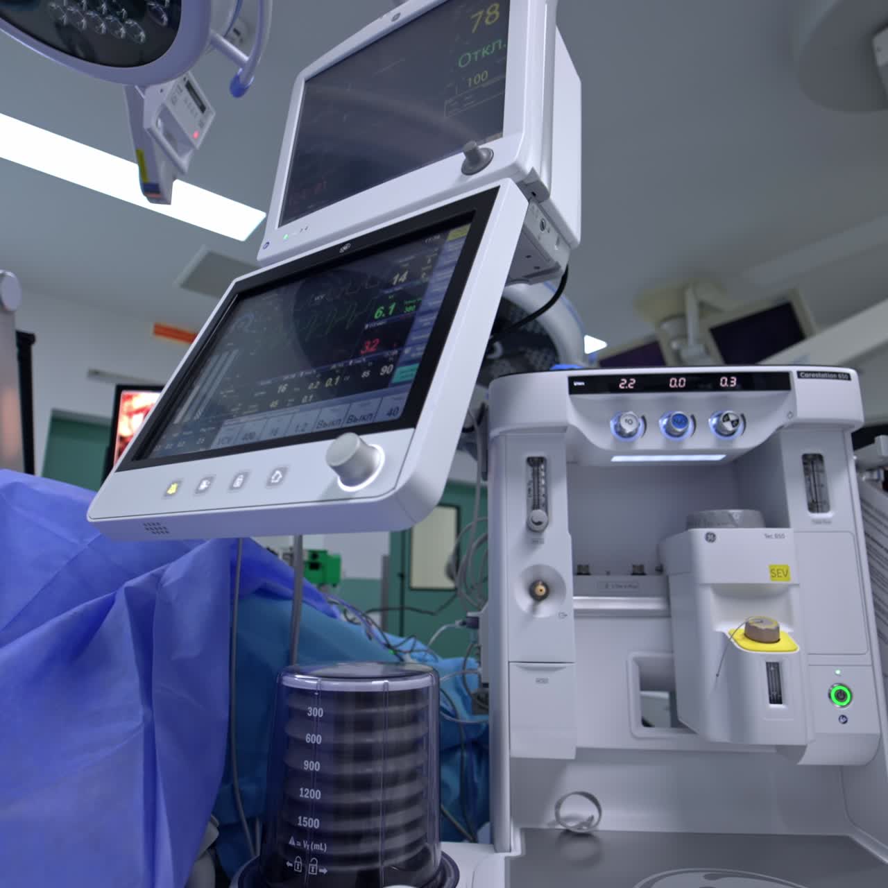 Innovative modern equipment working during the surgery. Nurse standing at the apparatus controlling its functioning. Surgery displayed at the screen