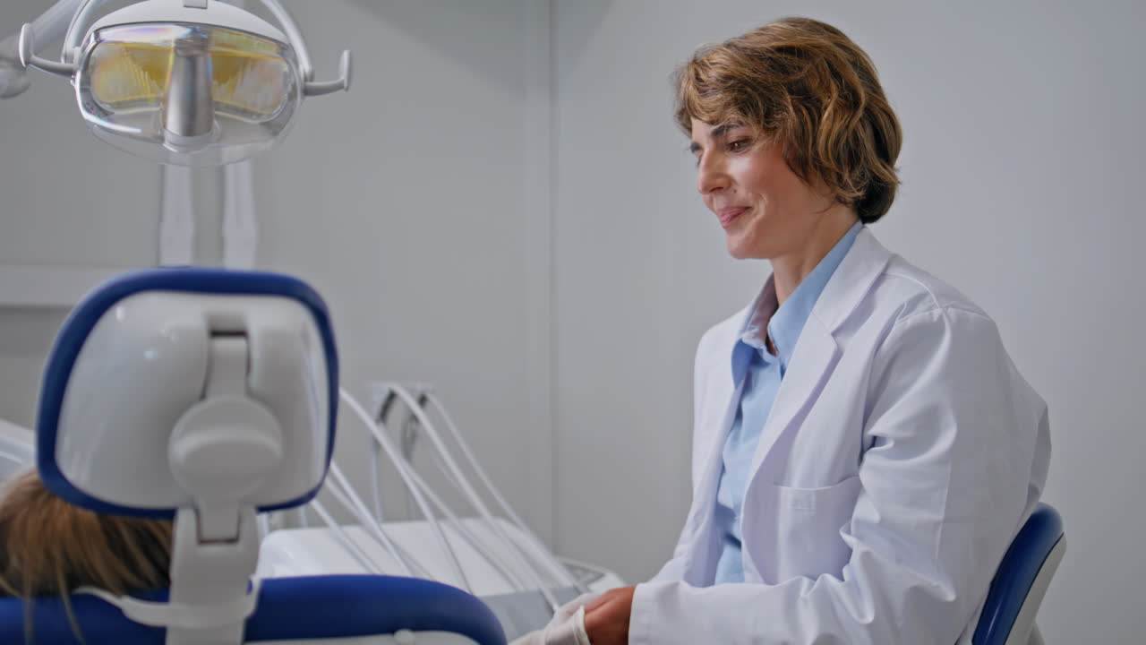 Friendly stomatologist wearing gloves for oral examination in clinic closeup