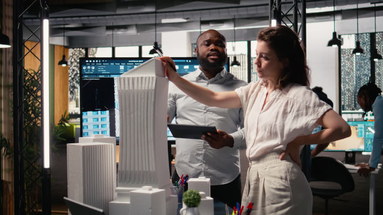 Real estate contractors team creating a modern smart city layout with 3D models