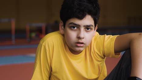 boy resting in running track