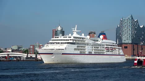 cruise liner in hamburg on departure, elbe and cityscape,