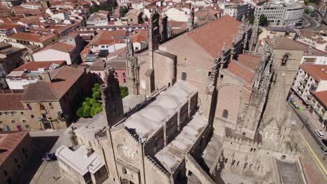 new cathedral of plasencia, historic romanesque style building, aerial orbiting shot