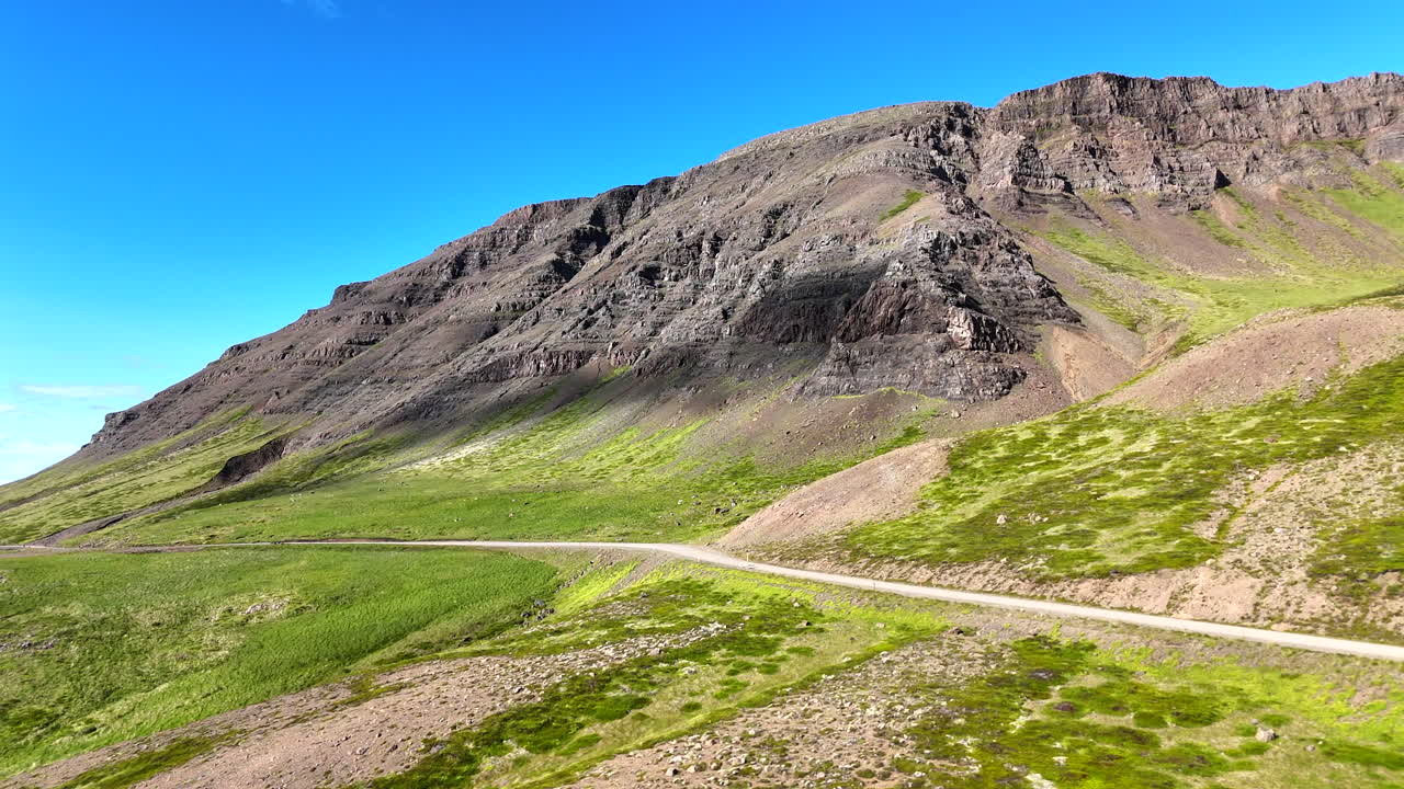 Aerial view of Hvammsfjörður in Vesturland Iceland on a colorful sunny day, showing vibrant waters, surrounding landscape, and clear blue sky from above
