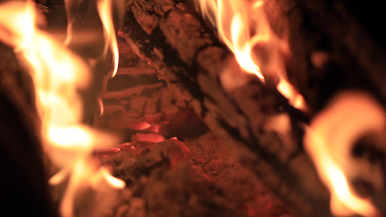 Close up shot of logs burning in a fire pit