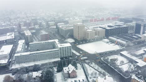 flying in a snow blizzard over urban area