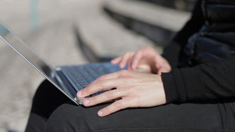 Nahaufnahme-Der-Hände-Junger-Mädchen-In-Warmer-Schwarzer-Weste,-Die-Am-Laptop-Arbeiten