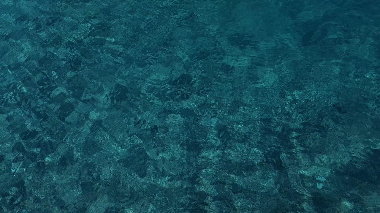 Abstract background in motion, emerald sea water reflecting sunbeams on beautiful texture, copy space for summer vacation