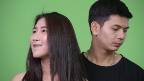 young asian couple thinking together differently