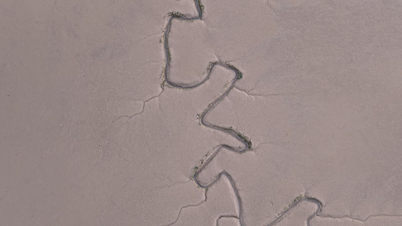 Aerial view looking down at Maldon saltmarsh thunderbolt texture in Essex low tide tidal marshland