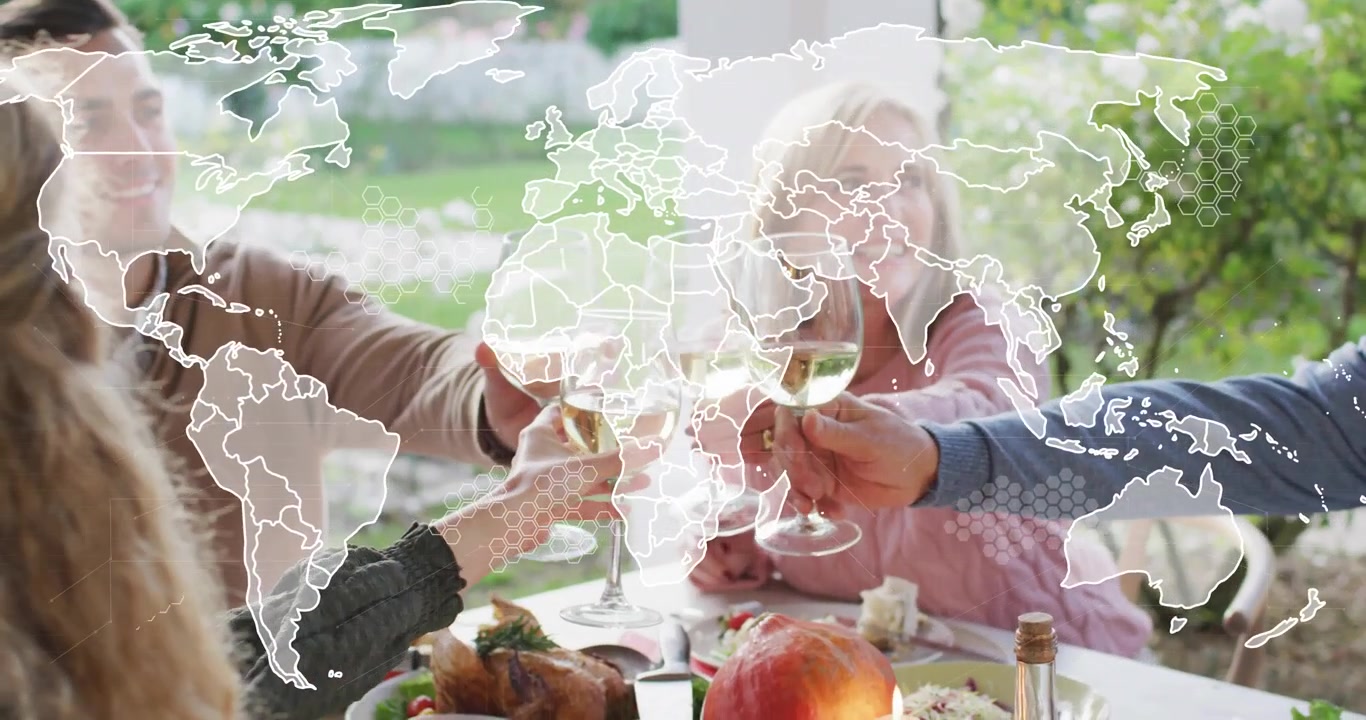 Familie skåler med vin på terrassen med en falmende verdenskortoverlejring, der forbinder spisende gæster globalt for turisme.
