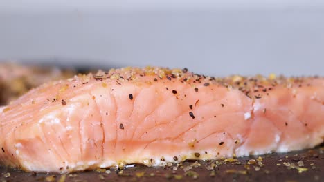 sushi de salmón crudo crudo que se cocina con especias que se rocían para sazonar la comida, cierre la vista lateral estática